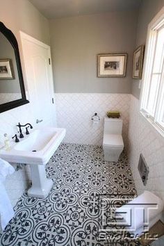 a bathroom with black and white tile flooring