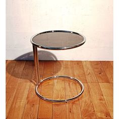 a small round table sitting on top of a wooden floor