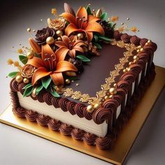 a heart shaped cake decorated with flowers and pearls on a gold plated platter