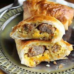 two sausage and egg breakfast rolls on a plate