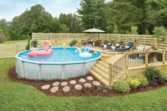 an above ground pool with a deck and inflatable flamingo floater next to it