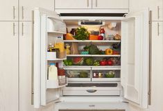 an open refrigerator filled with lots of different types of vegetables and fruit in it's door