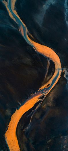 an aerial view of a river running through the land with yellow paint on it's sides