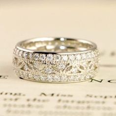 a wedding ring sitting on top of a piece of paper