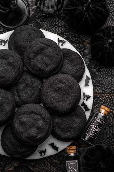 a white plate topped with black cookies on top of a table