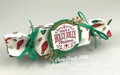 an ornament is attached to the top of a candy wrapper with ribbon