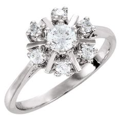 a white gold ring with diamonds in the middle and an oval center surrounded by small round stones