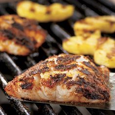 fish and pineapples are cooking on the grill