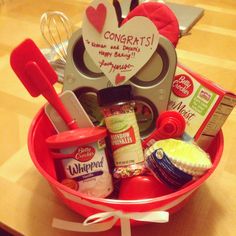 a red bowl filled with lots of food on top of a wooden table