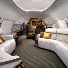 the inside of an airplane with couches and chairs