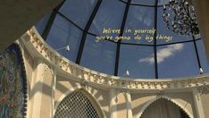 the inside of a building with a glass dome and chandelier hanging from it's ceiling