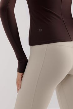 Meet our Mousse Long Sleeve Sports Top, a sleek active shirt designed to help you move to your own rhythm. A slim fit cut and middle-seam detail add a touch of informal elegance to this piece, making it ideal for mixing & matching with your favorite leggings and bottoms for any gym-to-street look! Fit tip: if you're in between sizes, we recommend sizing up. Details Materials & Care Shipping & Returns • High neckline with long sleeves and a thumbhole design for optimal flexibility while staying s Sleek Fitted Activewear For Workout, Sleek High-stretch Nylon Activewear, Sleek Fitted Activewear For Sports, Fitted Nylon Tops With Moisture-wicking, Fitted Nylon Athleisure Top, Nylon Athleisure Activewear, Fitted Moisture-wicking Nylon Tops, Compressive Elastane Tops For Training, Fitted Nylon Tops For Running