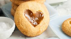 heart shaped cookies with peanut butter on top and sea salt in the middle, ready to be eaten