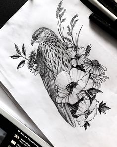 a bird sitting on top of a piece of paper next to some pens and ink