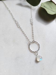 This lovely necklace features Moonstone and Herkimer Diamond (Quartz family) Gemstones. The monochromatic colors of these two gems make the necklace extra stunning! You can take this necklace from day to night and would look amazing for special occasions as well! Each necklace is handmade from your choice of Sterling Silver or 14K Gold Filled materials. The circle is hammered for shape and texture. About an inch up on each side of the chain is a beautiful row of Herkimer Diamonds. The length of Moonstone Birthstone Pendant Necklace, Moonstone Birthstone Pendant Necklaces, Moonstone Briolette Gemstone Necklace, Moonstone Gemstone Necklace In Briolette Shape, White Moonstone Briolette Necklace, White Briolette Moonstone Necklace, Moonstone Briolette Necklace For Gift, Briolette Moonstone Necklace For Gift, Dainty Moonstone Necklace For Anniversary