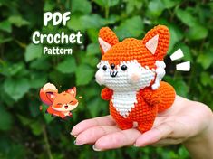 a small crocheted fox is in someone's hand