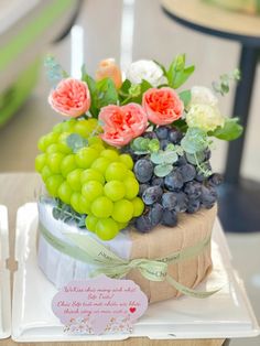 there is a cake with grapes and flowers on it