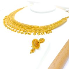 The Ornate Dangling Crescent 22k Gold Necklace Set, with a gold weight of 60.1 grams, is a magnificent piece showcasing luxurious craftsmanship. The set, adorned in yellow gold, features an elegant design with dangling crescent motifs that add a touch of celestial grace. The necklace's length is 18 inches, complemented by 0.8-inch adjustable links for a perfect fit. It's secured with a hook lock for comfort and safety. Included are matching earrings, each 1.25 inches in length, equipped with scr 22k Yellow Gold Bollywood Bridal Necklace, Yellow Gold Bollywood Bridal Necklace, Bollywood 22k Yellow Gold Bridal Necklace, Bollywood Style 22k Yellow Gold Bridal Necklace, 22k Yellow Gold Bollywood Kundan Necklace, 22k Yellow Gold Bridal Necklace For Festivals, Bollywood Style 22k Yellow Gold Kundan Necklace, 22k Yellow Gold Chandbali Kundan Necklace, 22k Yellow Gold Bridal Necklace For Diwali