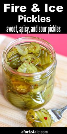 a jar filled with pickles sitting on top of a wooden table