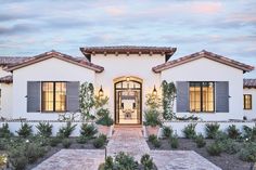 the front entrance to a home with brick walkway