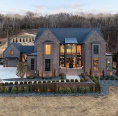 an aerial view of a large brick house with lots of windows and landscaping around it