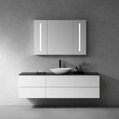 a bathroom with a sink, mirror and cabinet in black and white color scheme on the wall