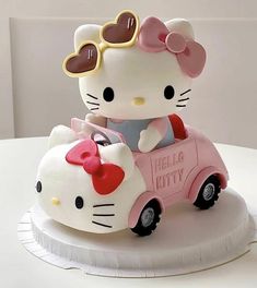 a hello kitty car cake with sunglasses on top