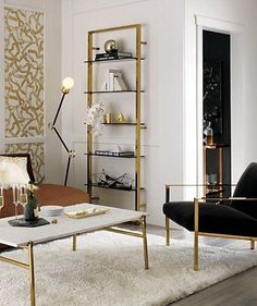 a living room filled with furniture and a white rug on top of a hard wood floor