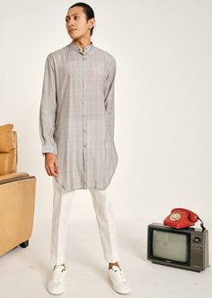 The grey stripe malai cotton kurta pajama set is constructed with a soft, lightweight fabric. The tonal print is contemporary and while it has a modern vibe, its color palette keeps it looking like a classic. This shirt style kurta comes with cuffed sleeves, a mandarin collar, two hip pockets on each side and has an angular hemline. The kurta is not lined. This is a 2 piece set complete with a cream trouser style cotton pajama. The trouser style pajama features an elasticated back, zip and fly front closure and two hip pockets and an ankle slit to make the slim fit comfortable to get in and out of. Men's Indian Style, Men's Business Casual Style, Kurta Set For Men, Cream Trousers, Kurta Pajama, Cotton Kurta, Trouser Style, Indian Outfit, Menswear Inspired