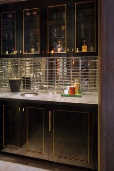 a kitchen that has some glass cabinets and counter tops on the wall in front of it