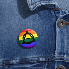 a button with the letter a on it sitting in a jean jacket's pocket