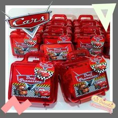 red plastic lunch boxes with cars logos on the front and sides, all lined up together