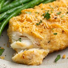 a white plate topped with green beans and chicken