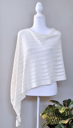 This off white merino wool lace knitted poncho is very elegant and is suited to complement different outfits, it is also suitable for weddings or other formal events in your life. It's the simplest way to add some colour and freshness to your wardrobe and stylize your everyday garments. A great gift for a loved one.    Knitted 100% merino wool ponchos. The poncho is available in one size. ❤️ Several wearing variants: as poncho, scarf, headgear, beach tunic, scarf, cape, vest and etc. ❤️ Handmade with love for you Gift wrapping available.  Hand washed in lukewarm water with delicate detergent, better flat to dry.  Please note that the colours might be a little different on your computer screen. Elegant One-size Cape Poncho, Elegant One Size Cape Poncho, Elegant One-size Cashmere Poncho, Oversized Elegant Cape For Spring, Elegant One Size Shawl Poncho, Elegant One-size Shawl Poncho, Elegant Shawl Wrap For Layering, Elegant Shawl Wraps For Layering, Elegant Oversized Poncho For Spring