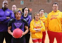 a group of people standing on top of a basketball court with a ball in front of them