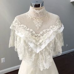 a white dress on a mannequin with lace overlaying the neckline