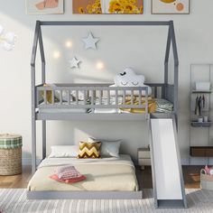 a child's bedroom with a bunk bed and slide in the middle, along with pictures on the wall