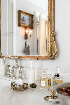 a bathroom sink with soap, lotion and other personal care items on the counter