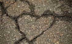 a heart shaped rock is shown in the middle of it's cracky surface