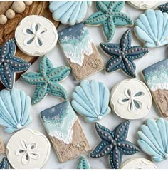 decorated cookies with shells and starfishs are displayed on a table next to beads