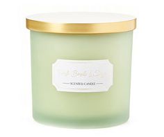 a green candle with a gold lid