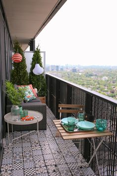 a balcony with two chairs and a table on it