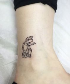 a small tattoo on the ankle of a woman's foot with an animal design