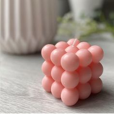 a pink candle sitting on top of a wooden table