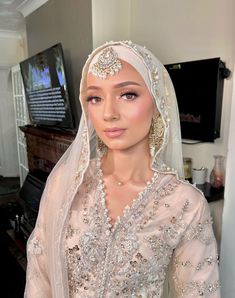 a woman wearing a veil and head piece