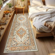 a bedroom with a large rug on the floor in front of a bed and window