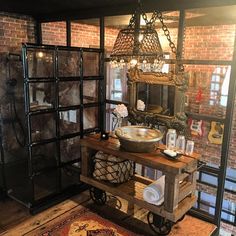 a room with a table, mirror and light fixture in the center is decorated with an old - fashion look