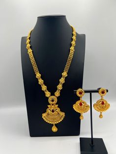 Embrace regal elegance with our exquisite 24K gold-plated Rani Haar set, a true masterpiece designed for the modern queen. This luxurious jewelry set, inspired by traditional royal designs, is perfect for weddings, special occasions, or adding a touch of grandeur to your collection. Care Instructions: To maintain the pristine condition of your Rani Haar set, avoid direct contact with water, perfumes, and harsh chemicals. Store in a dry, cool place when not in use. Luxury Gold Plated Jewelry For Puja, Elegant 22k Gold Chandbali Jewelry Sets, Traditional Elegant Jewelry Sets For Ceremonial Occasions, Gold-plated Temple Necklace With Elegant Design, Regal Gold Jewelry For Formal Occasion, Temple Jewelry Sets With Intricate Design In Gold Plated, Gold Chandbali Filigree Jewelry Sets, Ceremonial Yellow Gold Jewelry Sets, Ceremonial Yellow Gold Hand Set Jewelry Sets