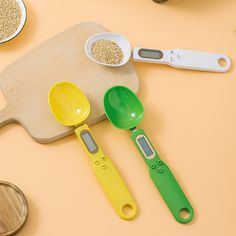 measuring spoons, measuring scale and other kitchen utensils on a yellow surface