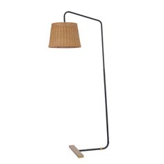 a floor lamp with a wooden base and a rattan shade on the top, against a white background